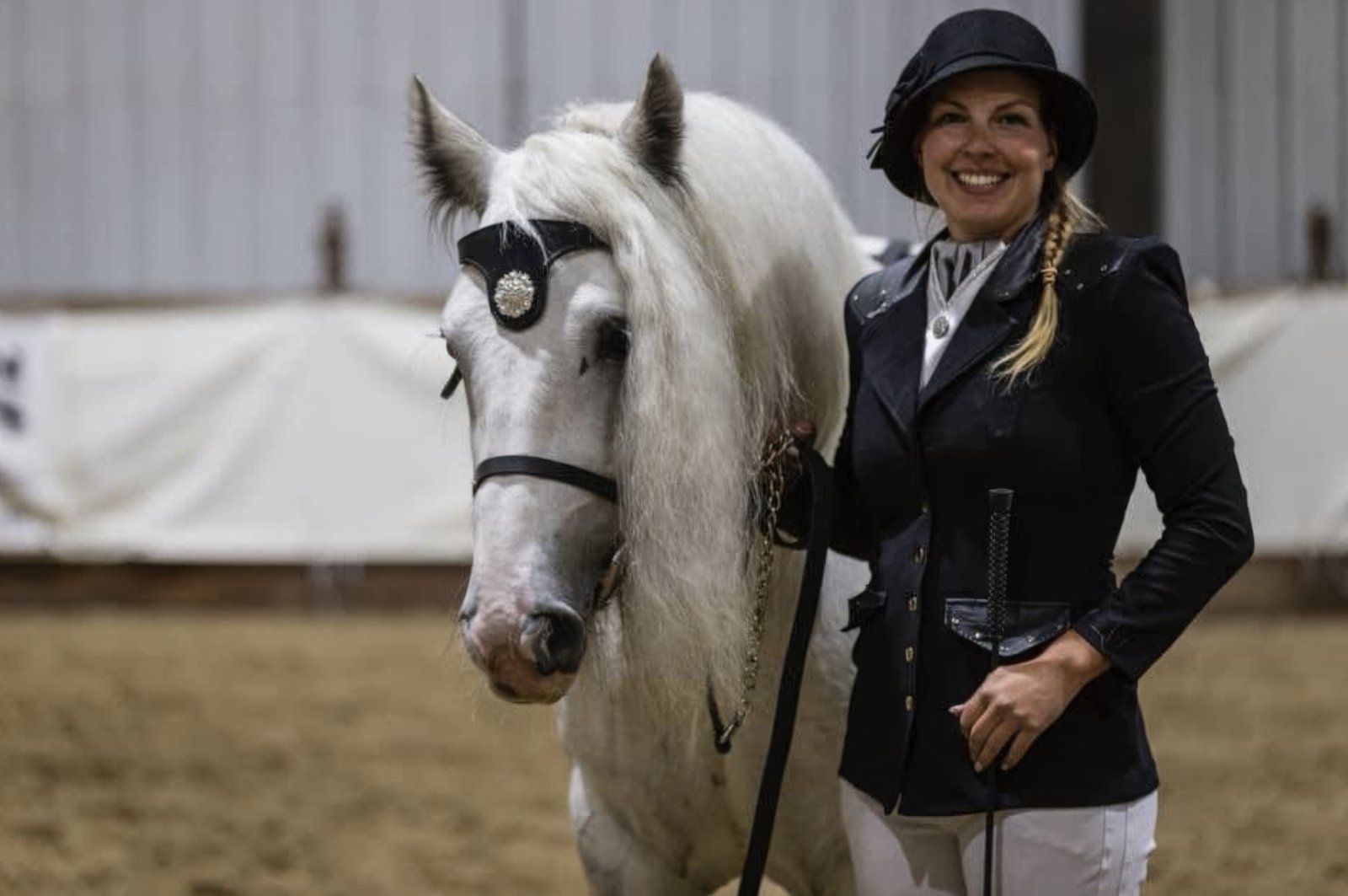 Cathy in show attire with her grey Gypsy horse